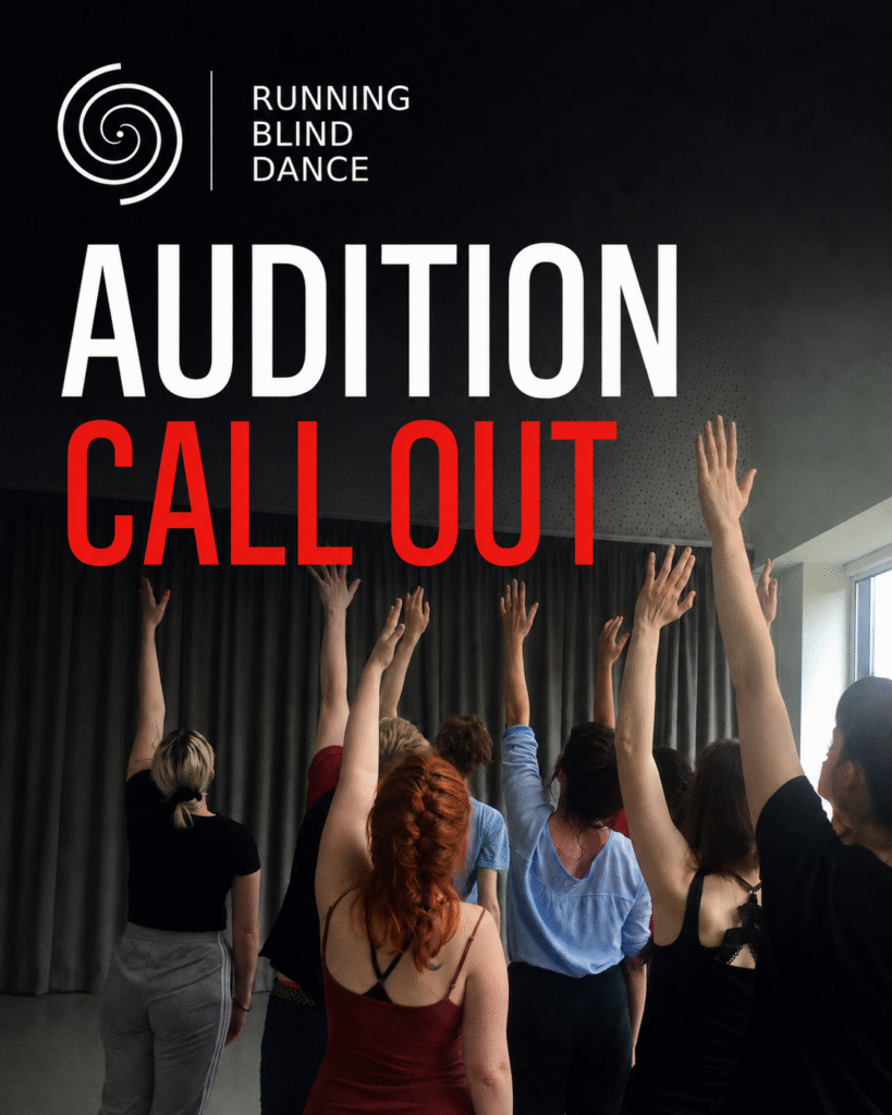 Around nine dancers are shown from behind in a dance studio, standing close together with their left arms raised overhead; a red-haired dancer in burgundy and a dark-haired dancer in black are prominent in the foreground. Dark curtains fill the background, with daylight coming through large windows on the right. At the top left corner of the image, the Running Blind Dance logo appears above large text reading “AUDITION CALL OUT” in white and red font.